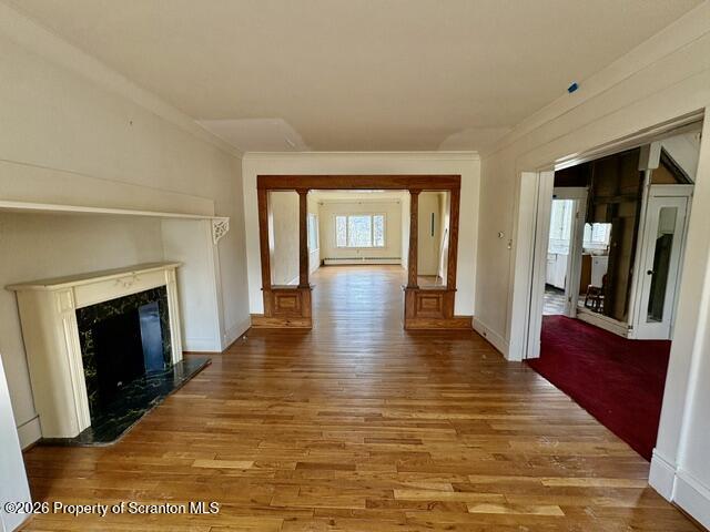 706 Delaware Street Forest City, PA 18421 - Photo 5 of 33 a view of an empty room with wooden floor and a fireplace