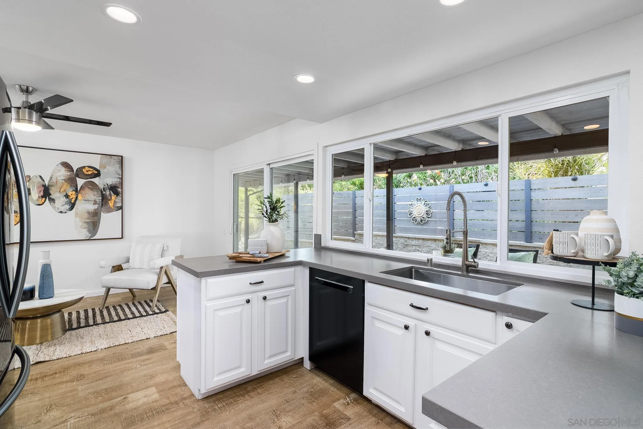 16556 Gabarda Road San Diego, CA 92128 - Photo 12 of 42 a kitchen with a sink and a large window
