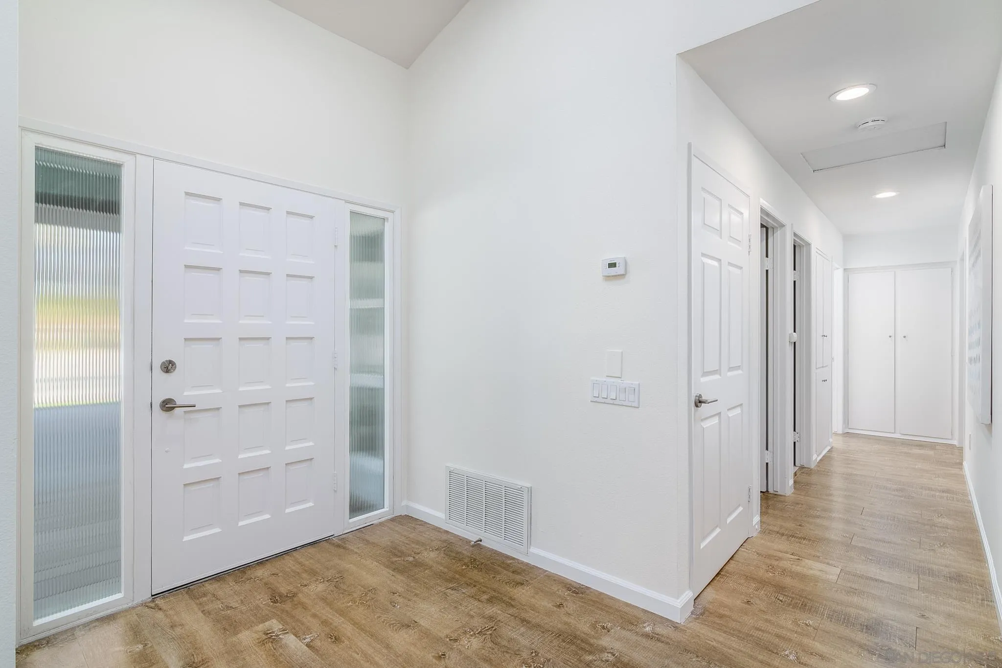 16556 Gabarda Road San Diego, CA 92128 - Photo 17 of 42 a view of hallway with closet and wooden floor