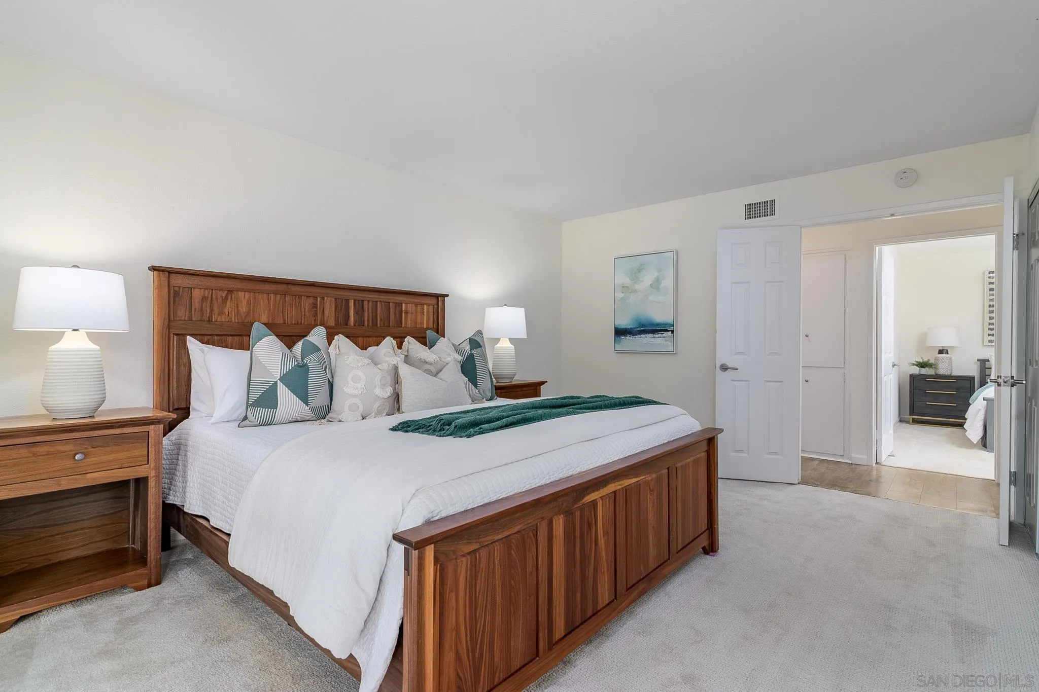 16556 Gabarda Road San Diego, CA 92128 - Photo 19 of 42 a spacious bedroom with a bed and a lamp