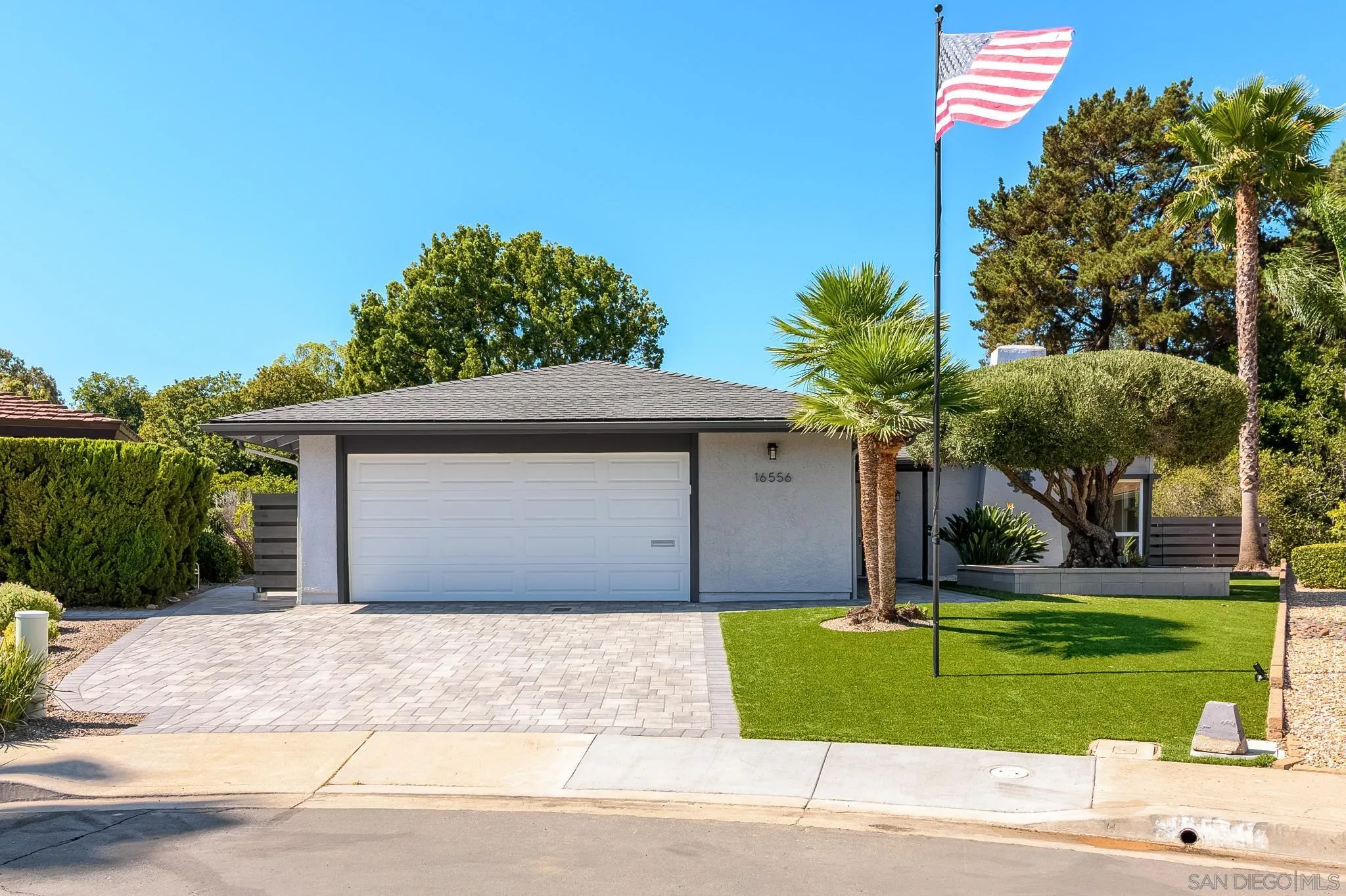 16556 Gabarda Road San Diego, CA 92128 - Photo 2 of 42 a front view of a house with a yard and garage