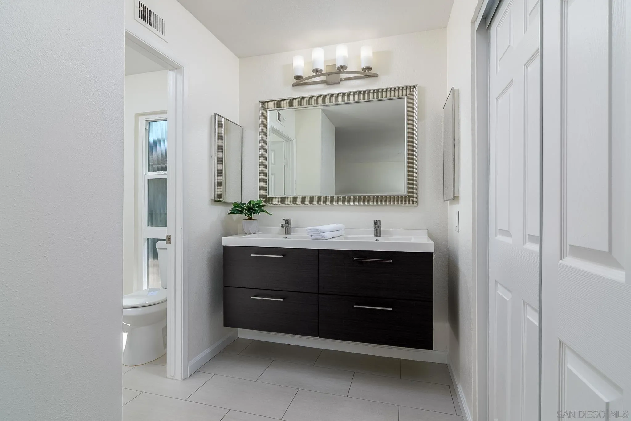 16556 Gabarda Road San Diego, CA 92128 - Photo 21 of 42 a bathroom with a sink and a mirror