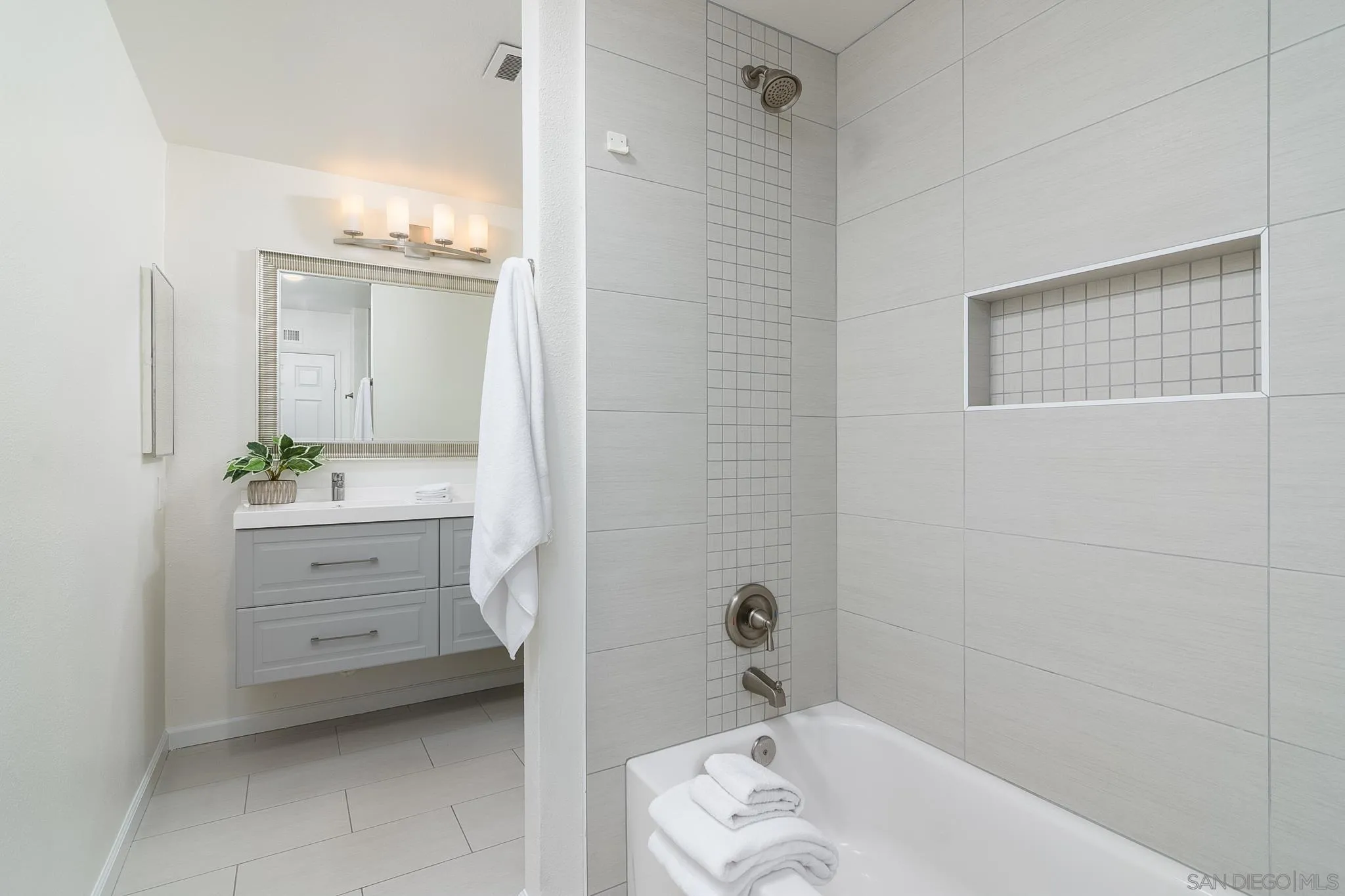 16556 Gabarda Road San Diego, CA 92128 - Photo 26 of 42 a bathroom with a bathtub sink and mirror