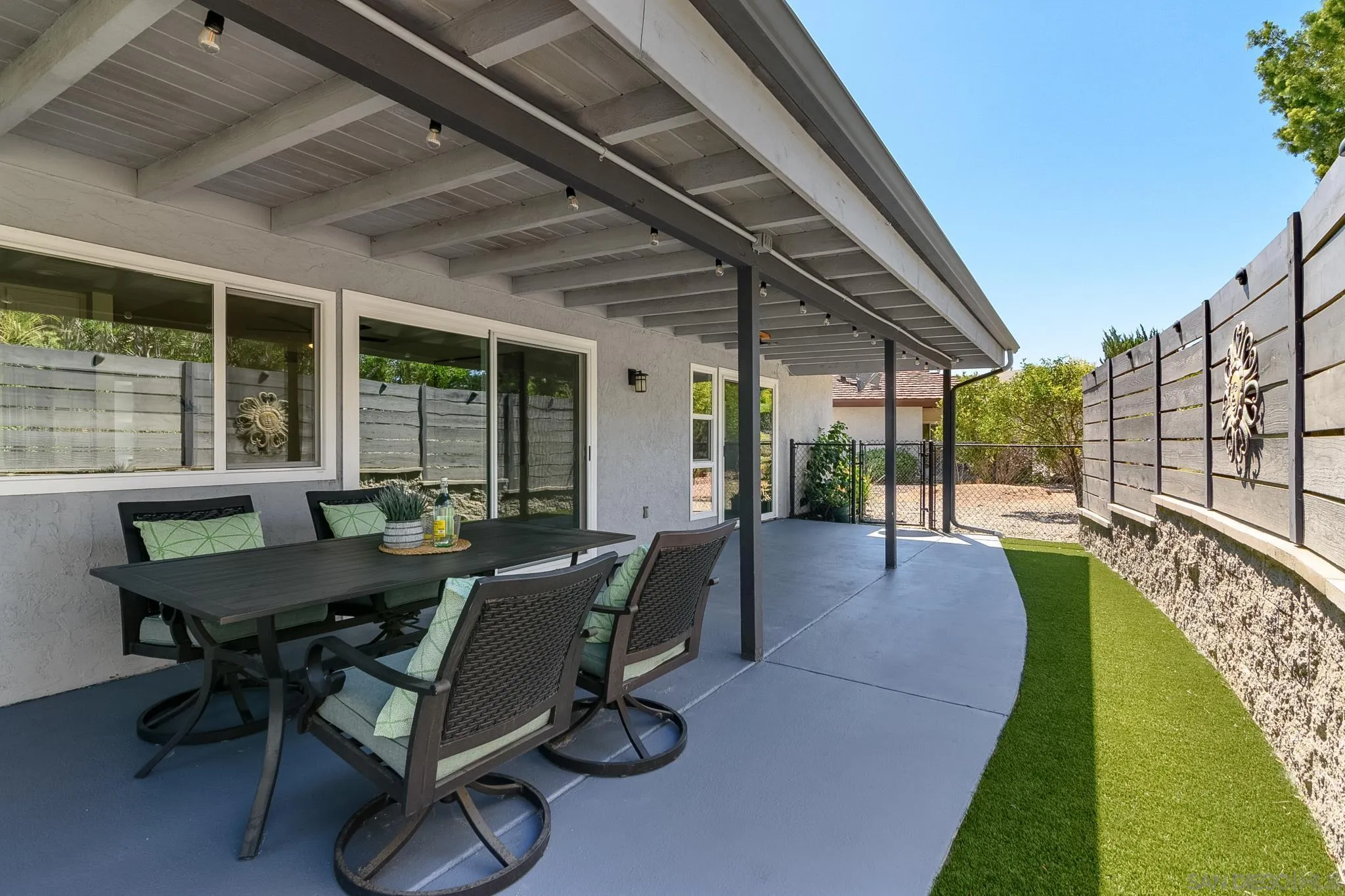 16556 Gabarda Road San Diego, CA 92128 - Photo 34 of 42 a view of a patio with table and chairs