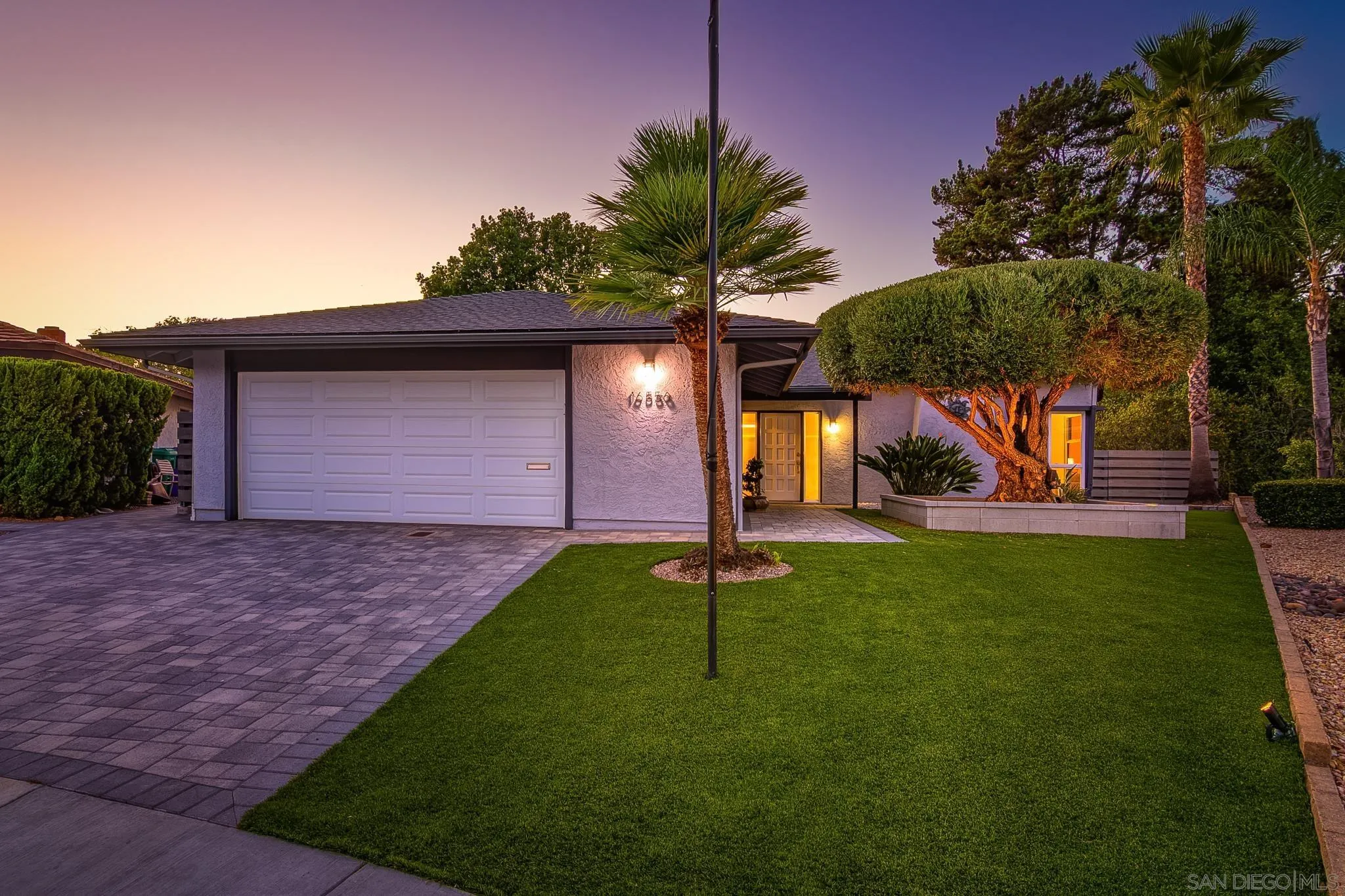16556 Gabarda Road San Diego, CA 92128 - Photo 4 of 42 a view of a backyard with a tree
