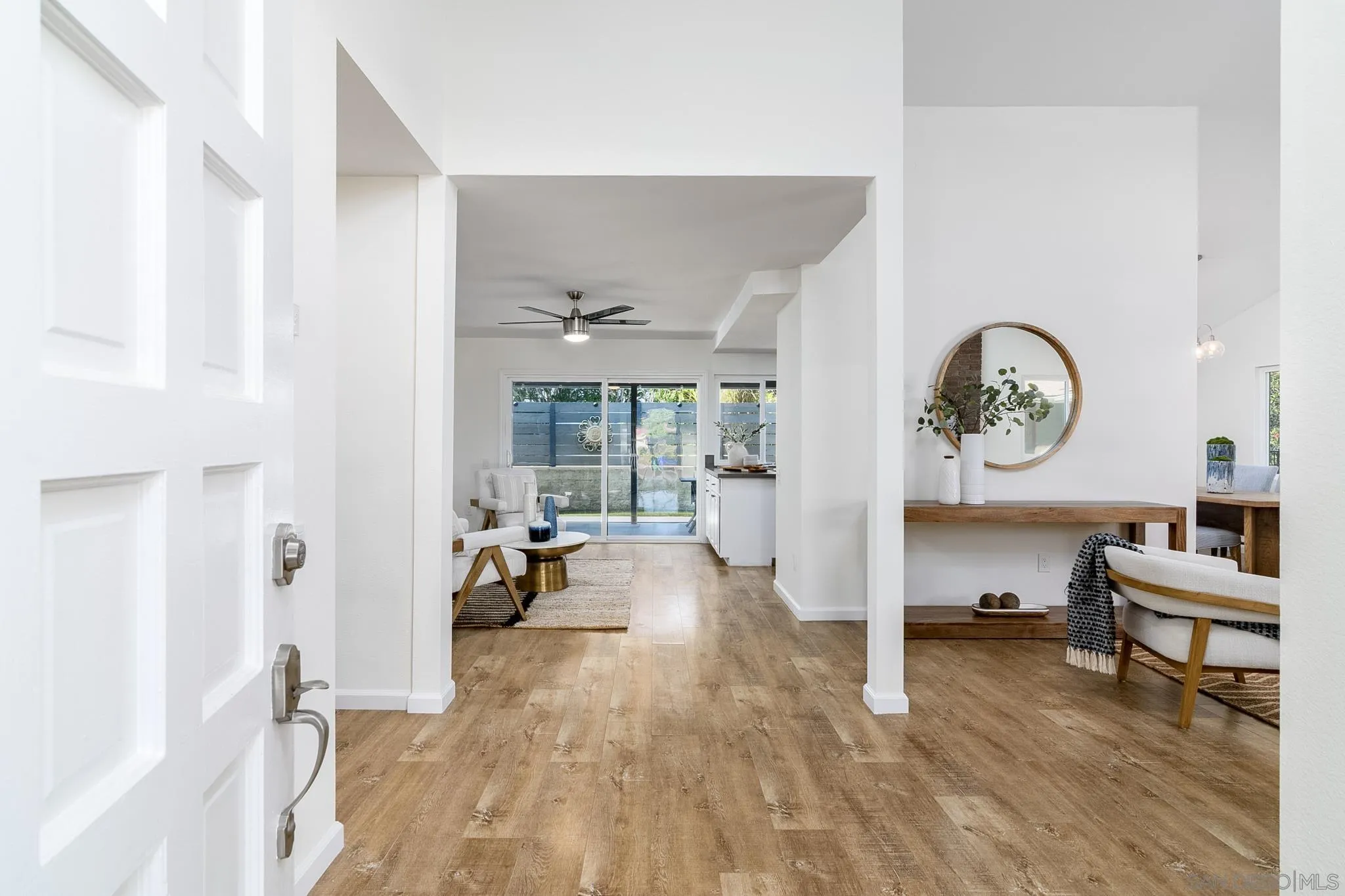 16556 Gabarda Road San Diego, CA 92128 - Photo 6 of 42 a living room with furniture a clock on wall and a large window