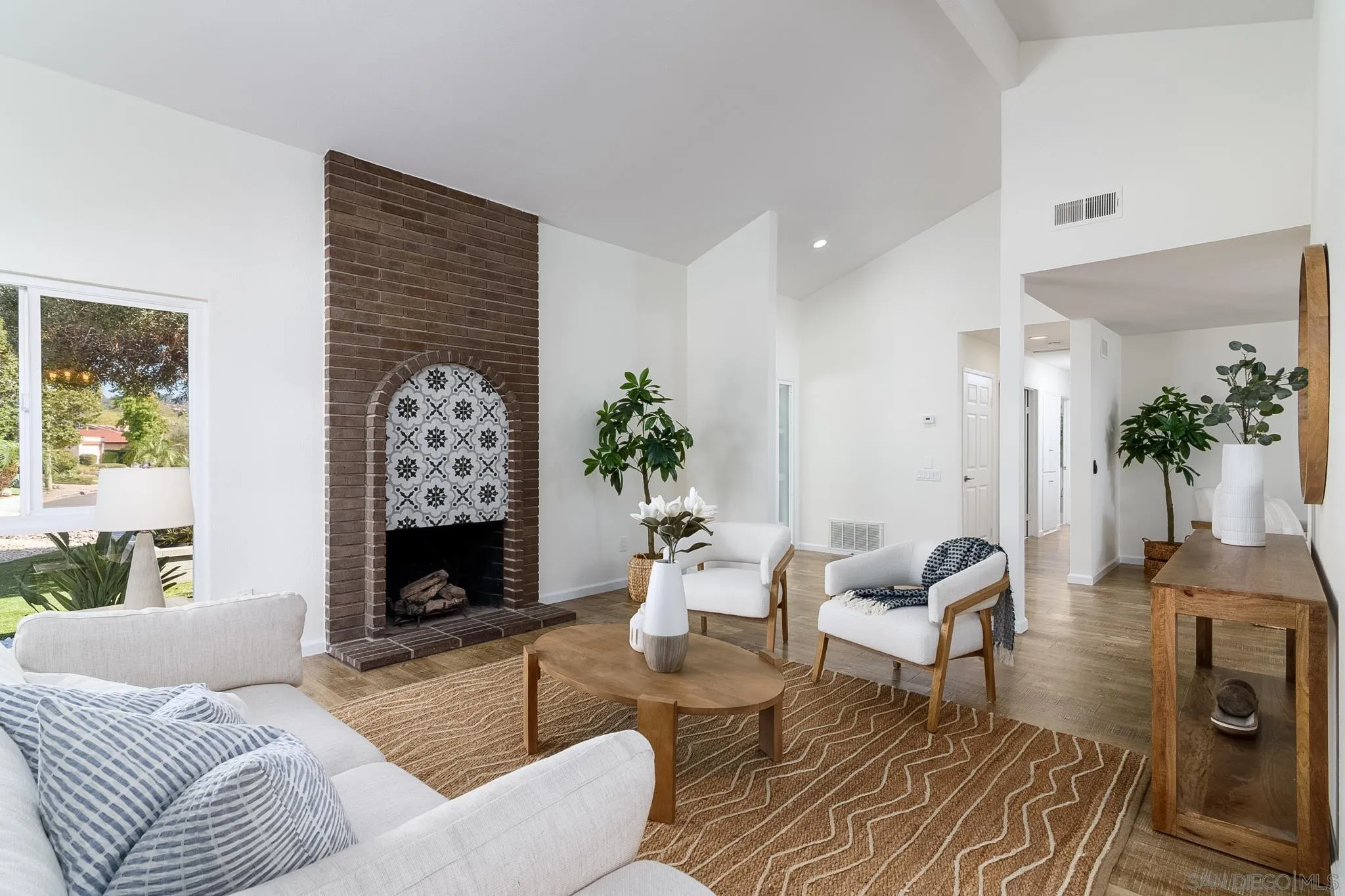 16556 Gabarda Road San Diego, CA 92128 - Photo 8 of 42 a living room with furniture and a fireplace