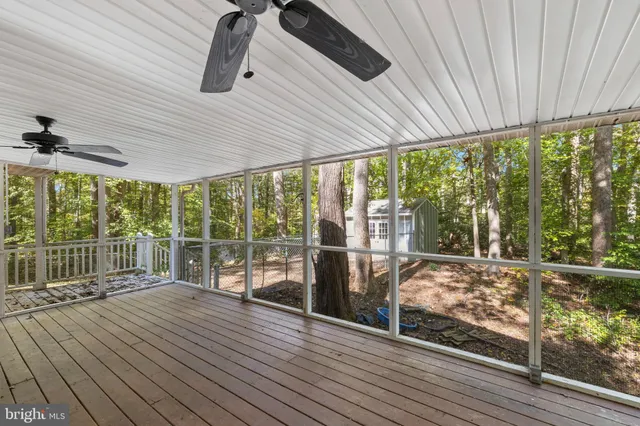a view of a livingroom with fireplace window and wooden floor