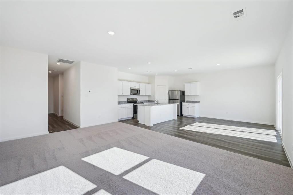 2012 Prairie Lane Melissa, TX 75454 - Photo 6 of 22 a view of kitchen and empty room