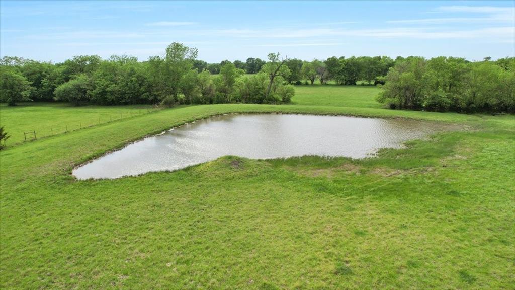 99 East Line Road Whitewright, TX 75491 - Photo 1 of 10 a view of a lake with a big yard