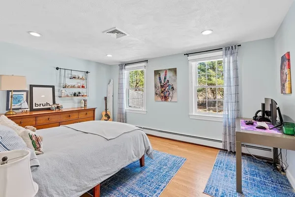 a bedroom with a bed and wooden floor