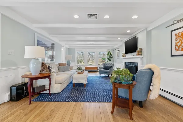 a living room with fireplace furniture and a flat screen tv