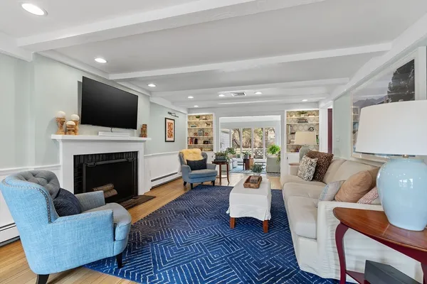 a living room with furniture fireplace and flat screen tv
