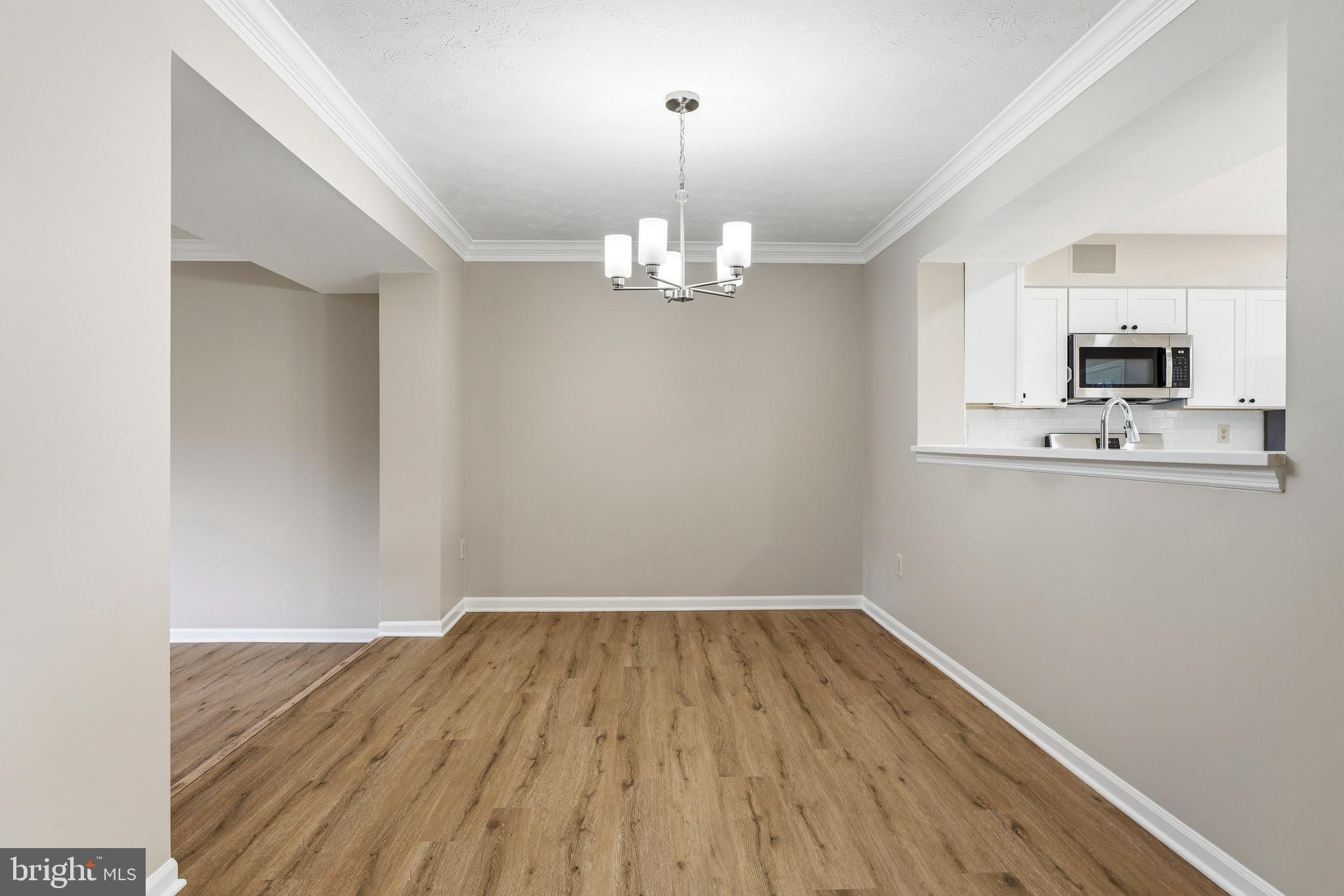 2717 Quarry Heights Way Baltimore, MD 21209 - Photo 11 of 58 a view of a kitchen with wooden floor and a sink