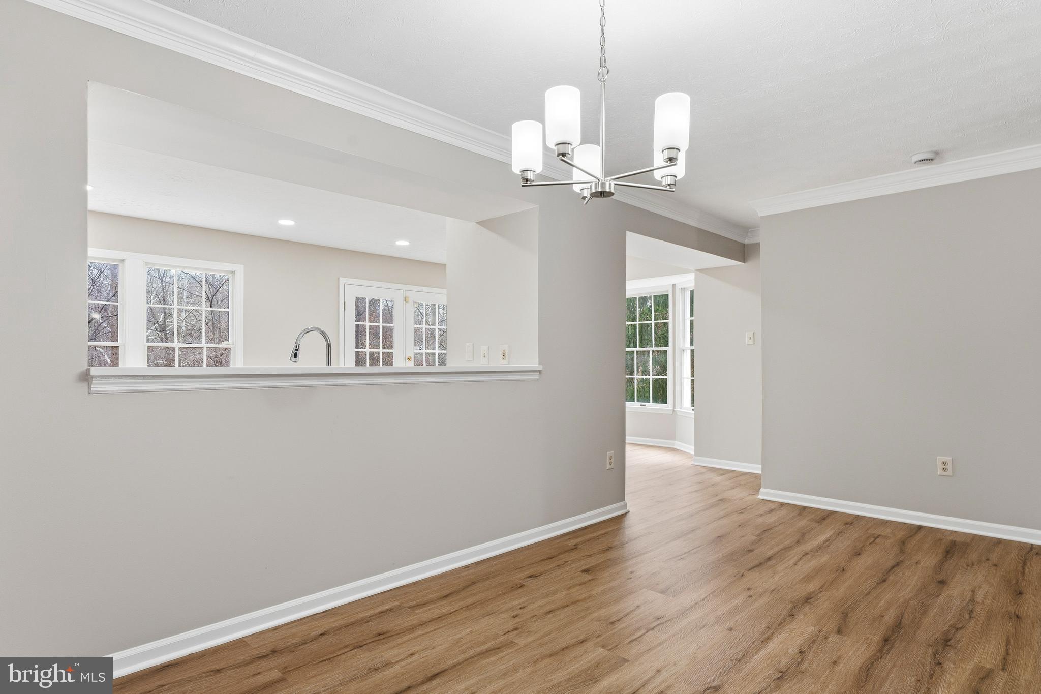 2717 Quarry Heights Way Baltimore, MD 21209 - Photo 12 of 58 a view of an empty room with wooden floor and a window