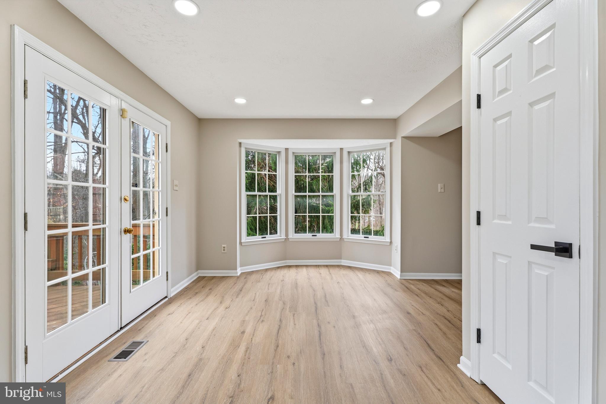 2717 Quarry Heights Way Baltimore, MD 21209 - Photo 20 of 58 a view of an empty room with wooden floor and a window