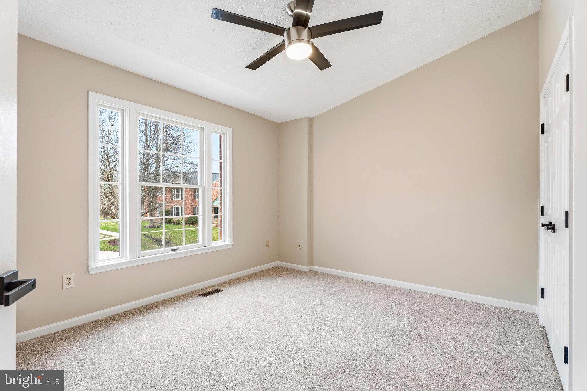 2717 Quarry Heights Way Baltimore, MD 21209 - Photo 38 of 58 an empty room with windows and fan