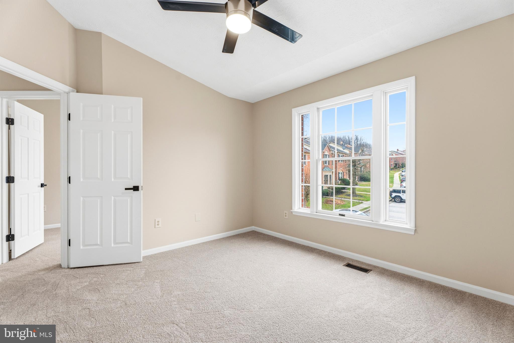 2717 Quarry Heights Way Baltimore, MD 21209 - Photo 39 of 58 an empty room with a window and a ceiling fan