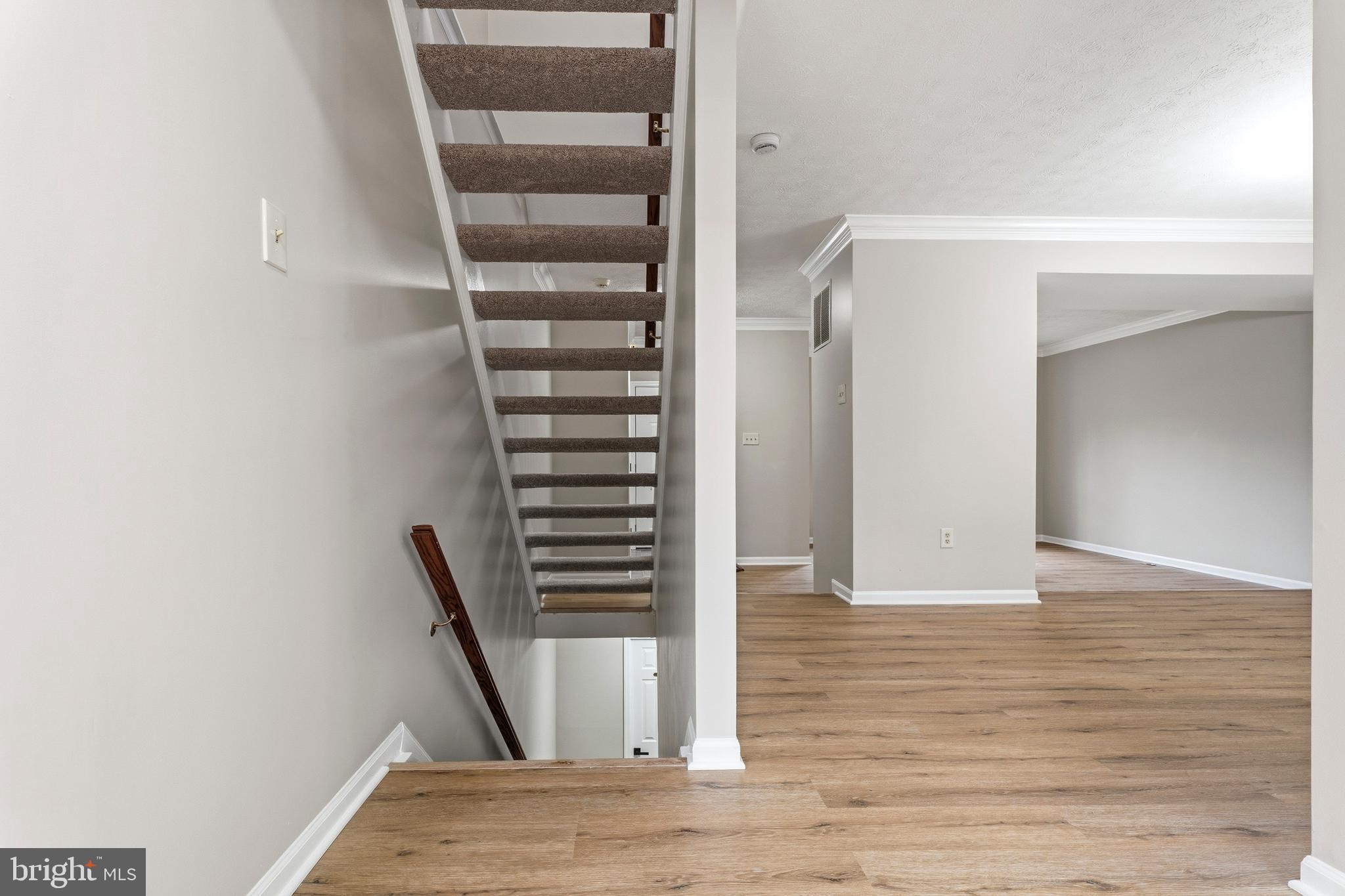 2717 Quarry Heights Way Baltimore, MD 21209 - Photo 45 of 58 a view of an empty room with wooden floor and entryway