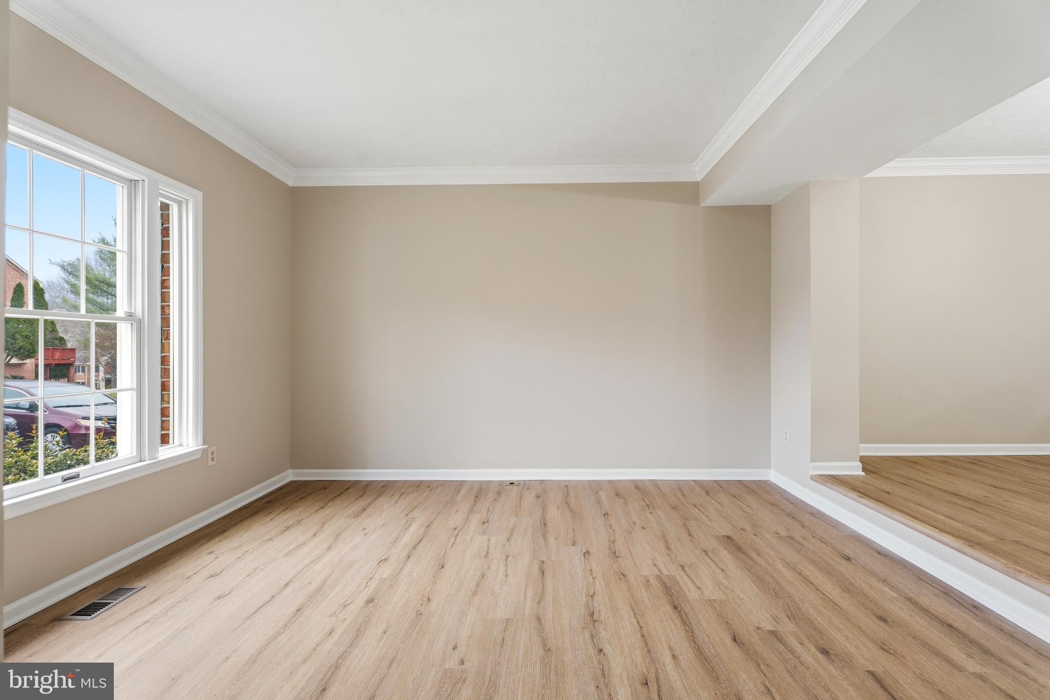 2717 Quarry Heights Way Baltimore, MD 21209 - Photo 5 of 58 a view of an empty room with wooden floor and a window