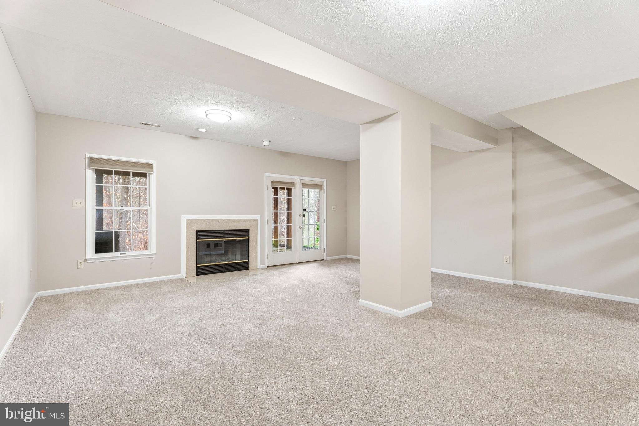 2717 Quarry Heights Way Baltimore, MD 21209 - Photo 51 of 58 an empty room with windows and fireplace