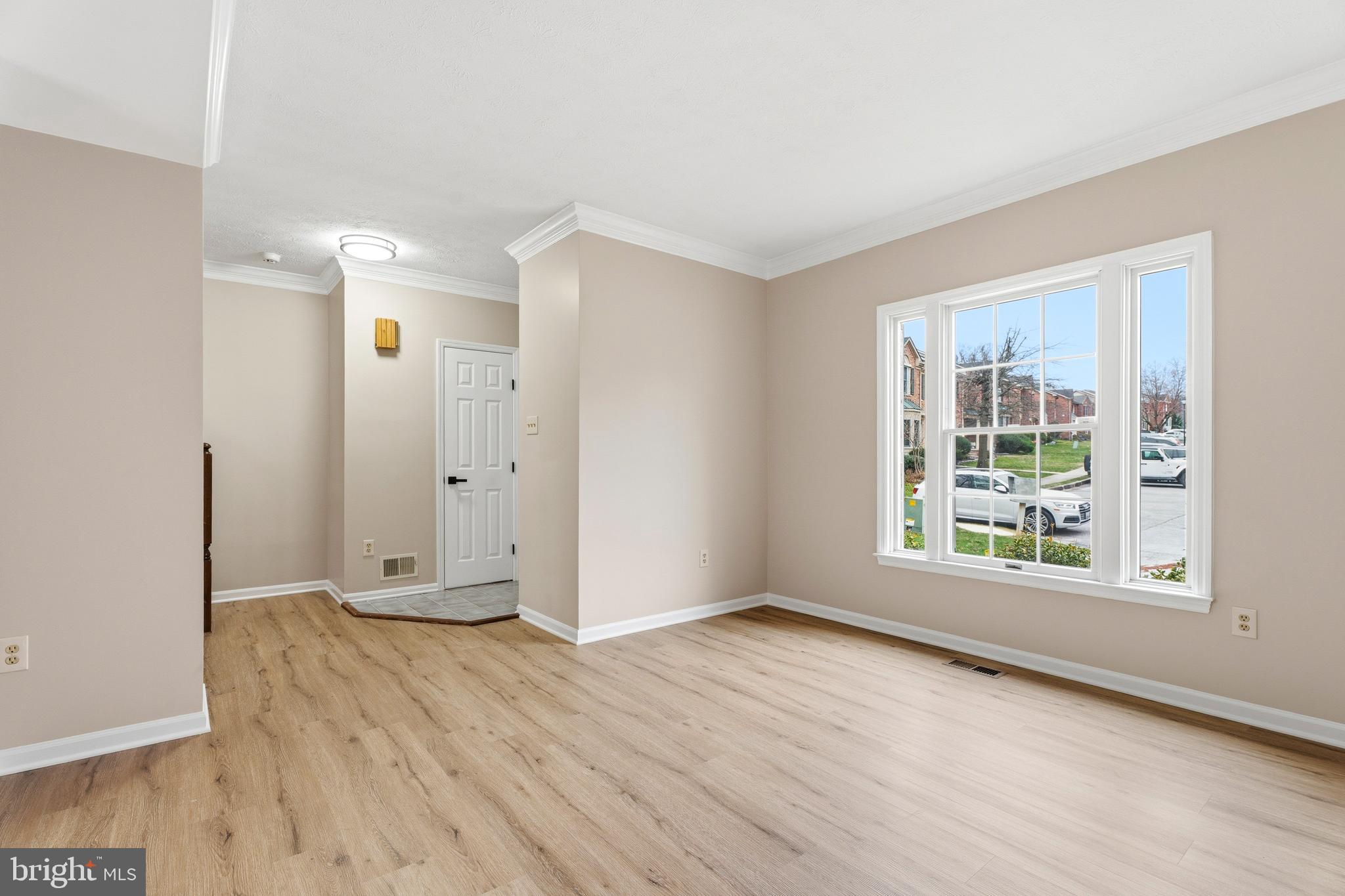 2717 Quarry Heights Way Baltimore, MD 21209 - Photo 6 of 58 an empty room with wooden floor and windows