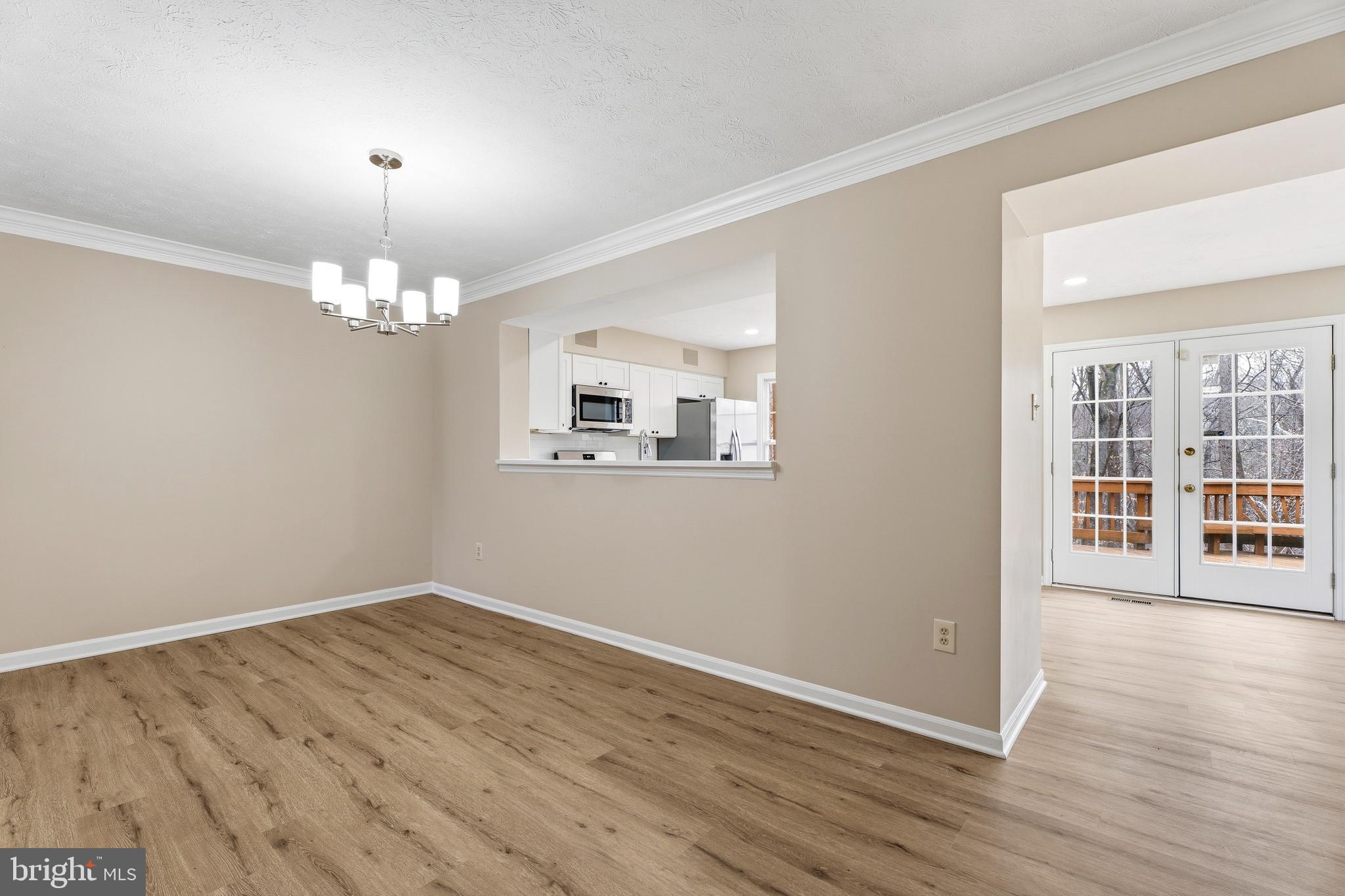 2717 Quarry Heights Way Baltimore, MD 21209 - Photo 9 of 58 a view of a room with wooden floor and chandelier