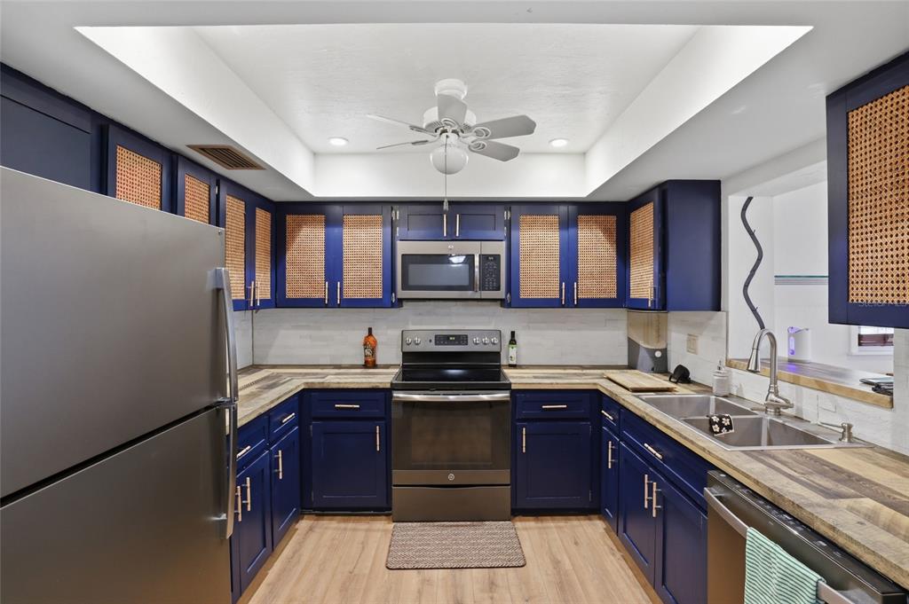 4576 Bliss Road Sarasota, FL 34233 - Photo 11 of 40 a kitchen with stainless steel appliances granite countertop a stove sink microwave and window