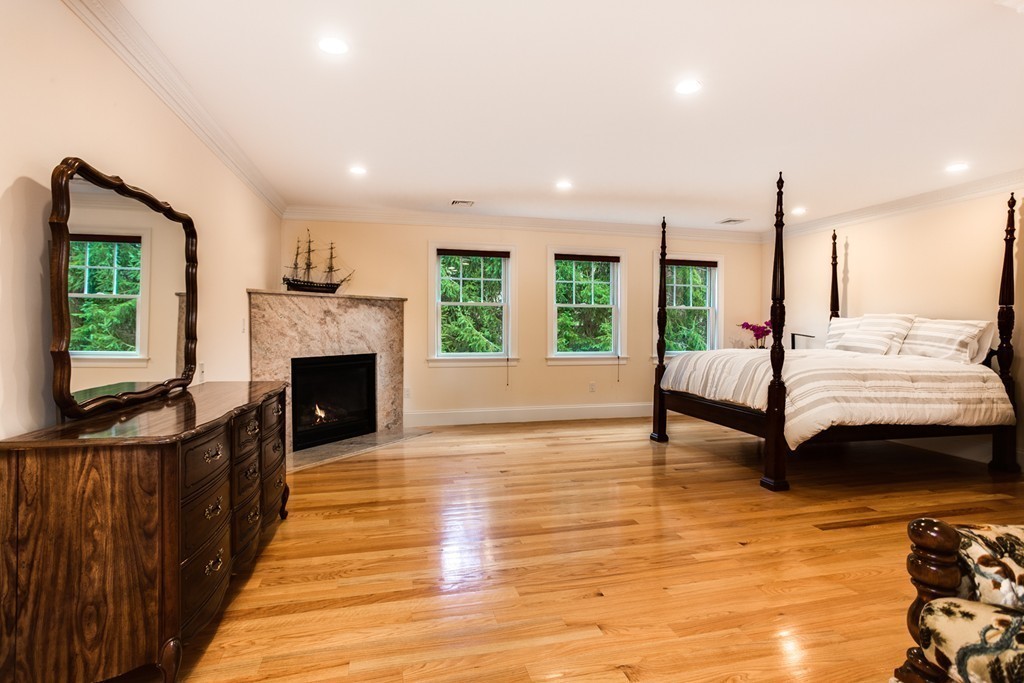 146 Pine Street Dover, MA 02030 - Photo 16 of 30 a spacious bedroom with a bed and a fireplace