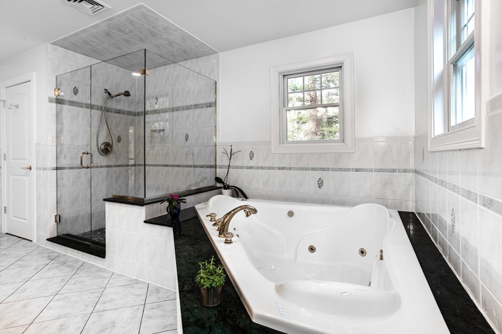 146 Pine Street Dover, MA 02030 - Photo 17 of 30 a bathroom with a white bath tub sitting next to a window