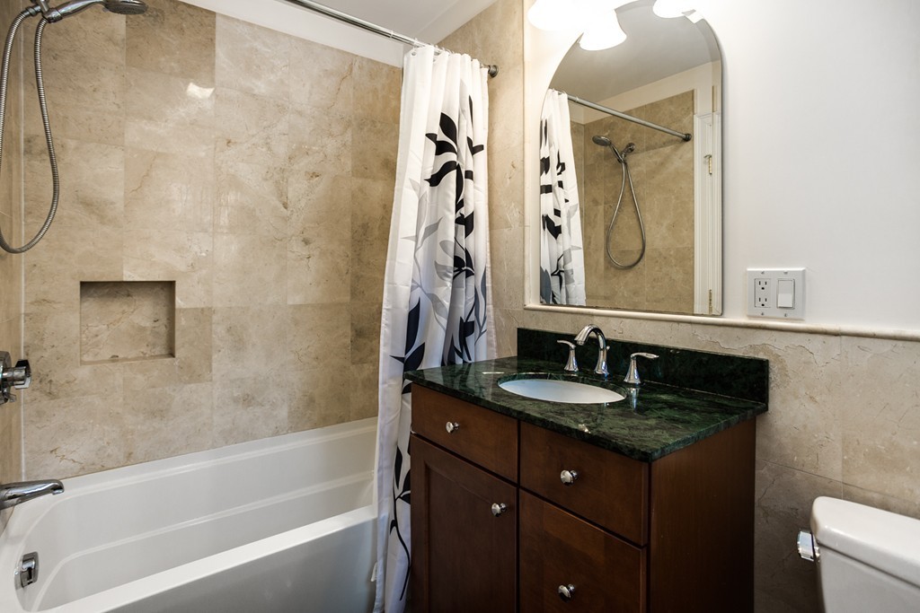 146 Pine Street Dover, MA 02030 - Photo 23 of 30 a bathroom with a granite countertop sink a toilet and bathtub