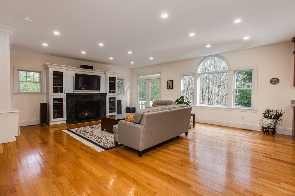 146 Pine Street Dover, MA 02030 - Photo 6 of 30 a living room with furniture a large window and a fireplace