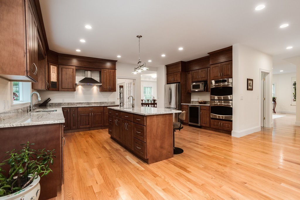146 Pine Street Dover, MA 02030 - Photo 8 of 30 a large kitchen with stainless steel appliances kitchen island granite countertop a large counter top and a stove