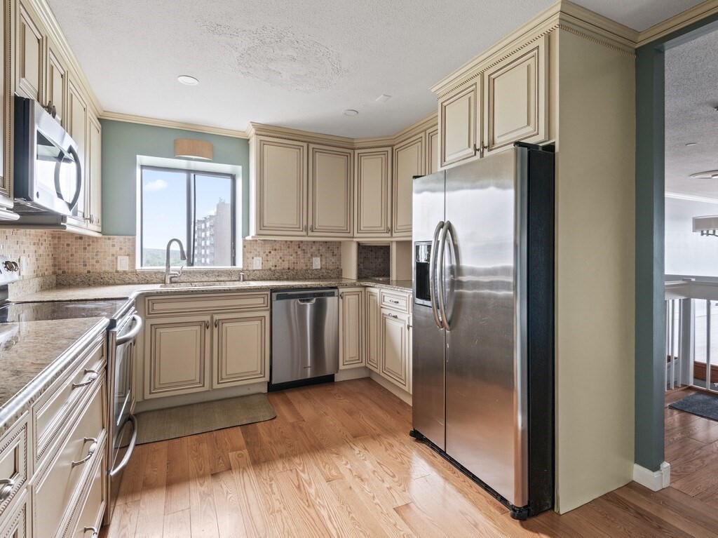 65 Lake Avenue, Unit 831 Worcester, MA 01604 - Photo 16 of 39 a kitchen with a refrigerator sink and cabinets