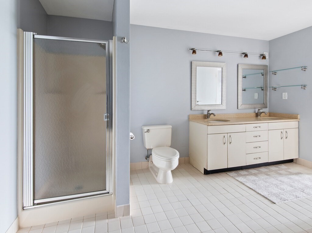 65 Lake Avenue, Unit 831 Worcester, MA 01604 - Photo 24 of 39 a bathroom with a sink a toilet and a mirror