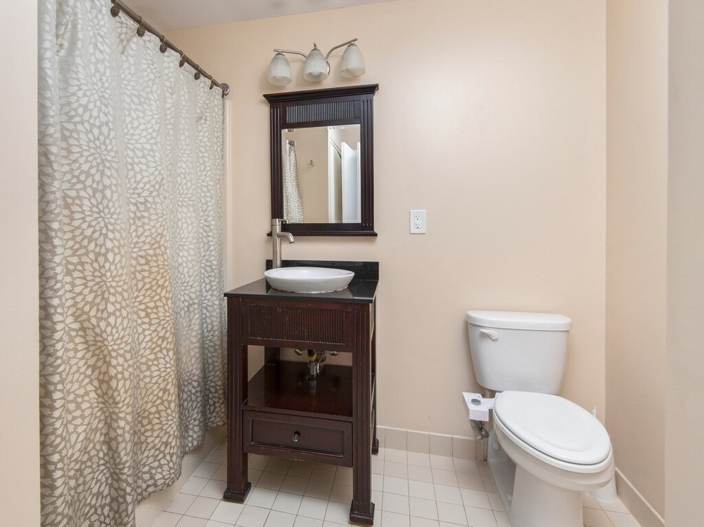 65 Lake Avenue, Unit 831 Worcester, MA 01604 - Photo 28 of 39 a bathroom with a toilet a sink and mirror