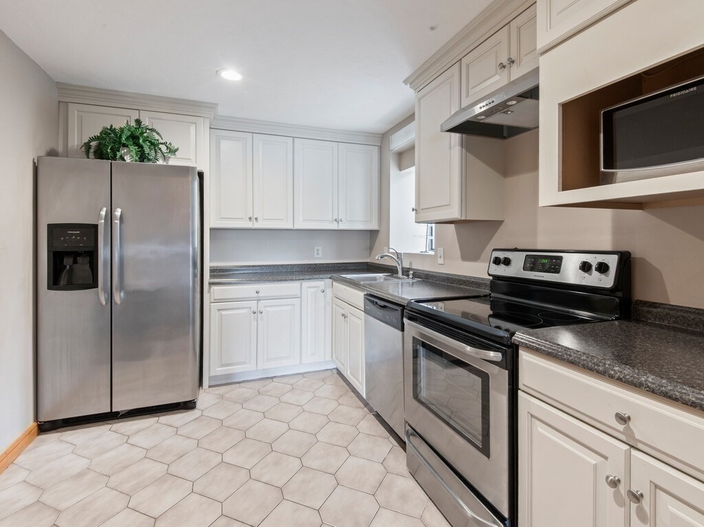 65 Lake Avenue, Unit 831 Worcester, MA 01604 - Photo 33 of 39 a kitchen with cabinets stainless steel appliances and a counter space