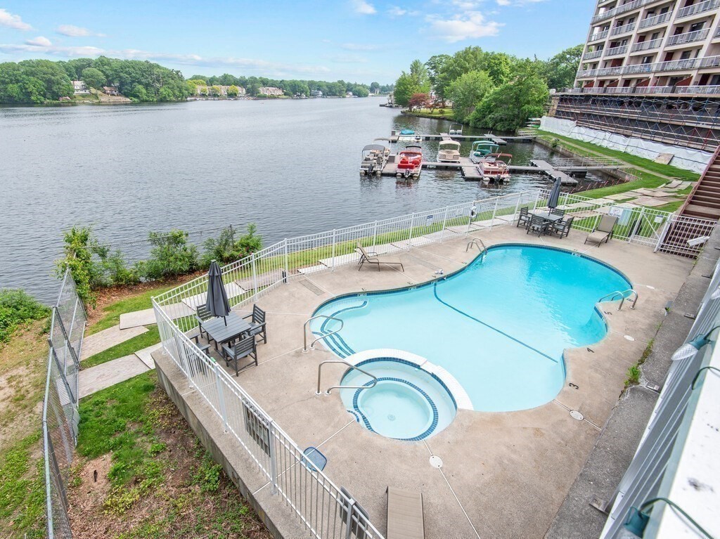 65 Lake Avenue, Unit 831 Worcester, MA 01604 - Photo 34 of 39 a view of a swimming pool with a patio and a lake view