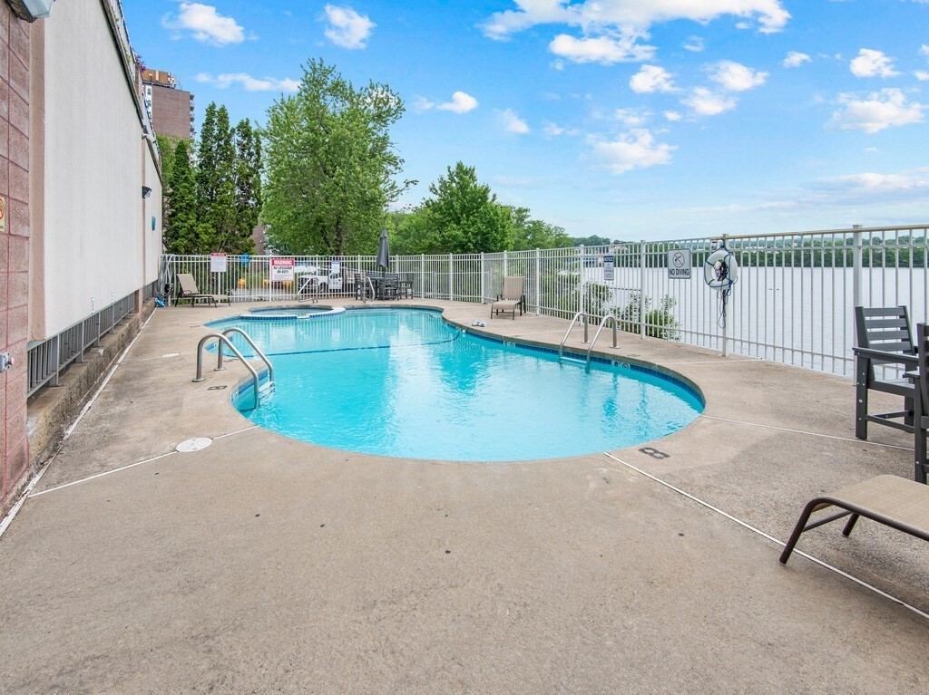 65 Lake Avenue, Unit 831 Worcester, MA 01604 - Photo 35 of 39 a view of a swimming pool with a lounge chair
