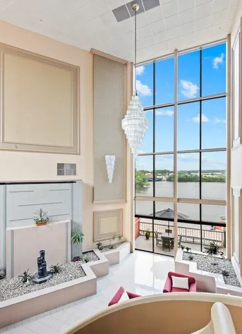 a living room with furniture and large windows