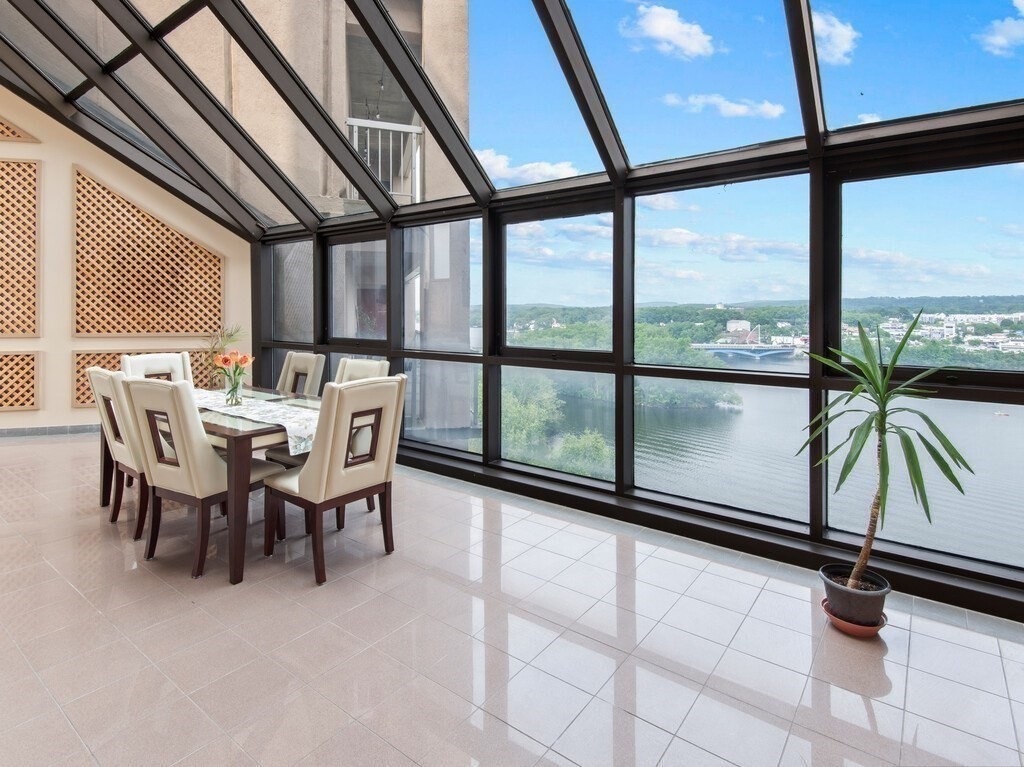 65 Lake Avenue, Unit 831 Worcester, MA 01604 - Photo 7 of 39 a dining room with furniture and floor to ceiling windows