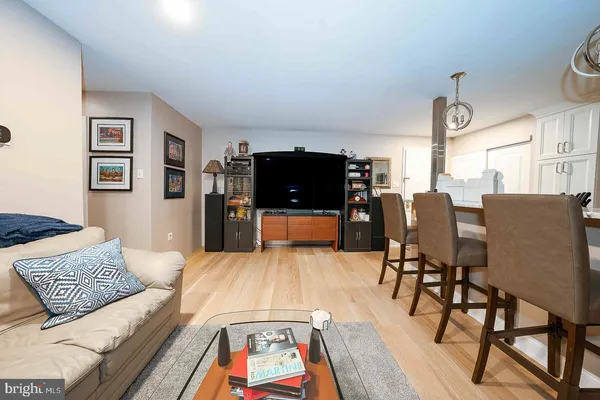 a living room with closet and a flat screen tv