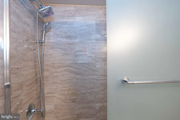 a bathroom with a glass shower door
