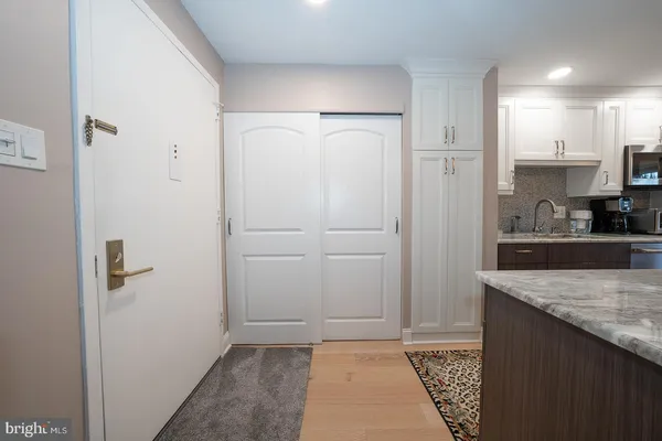 a view of hallway with closet and furniture