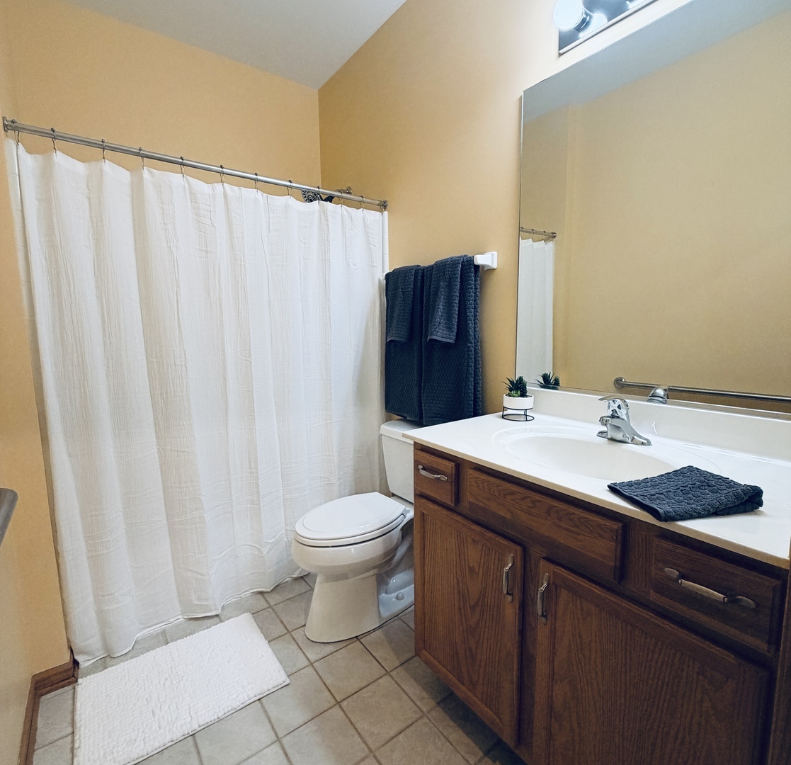 1534 Cadillac Circle Romeoville, IL 60446 - Photo 12 of 25 a bathroom with a granite countertop sink and a mirror