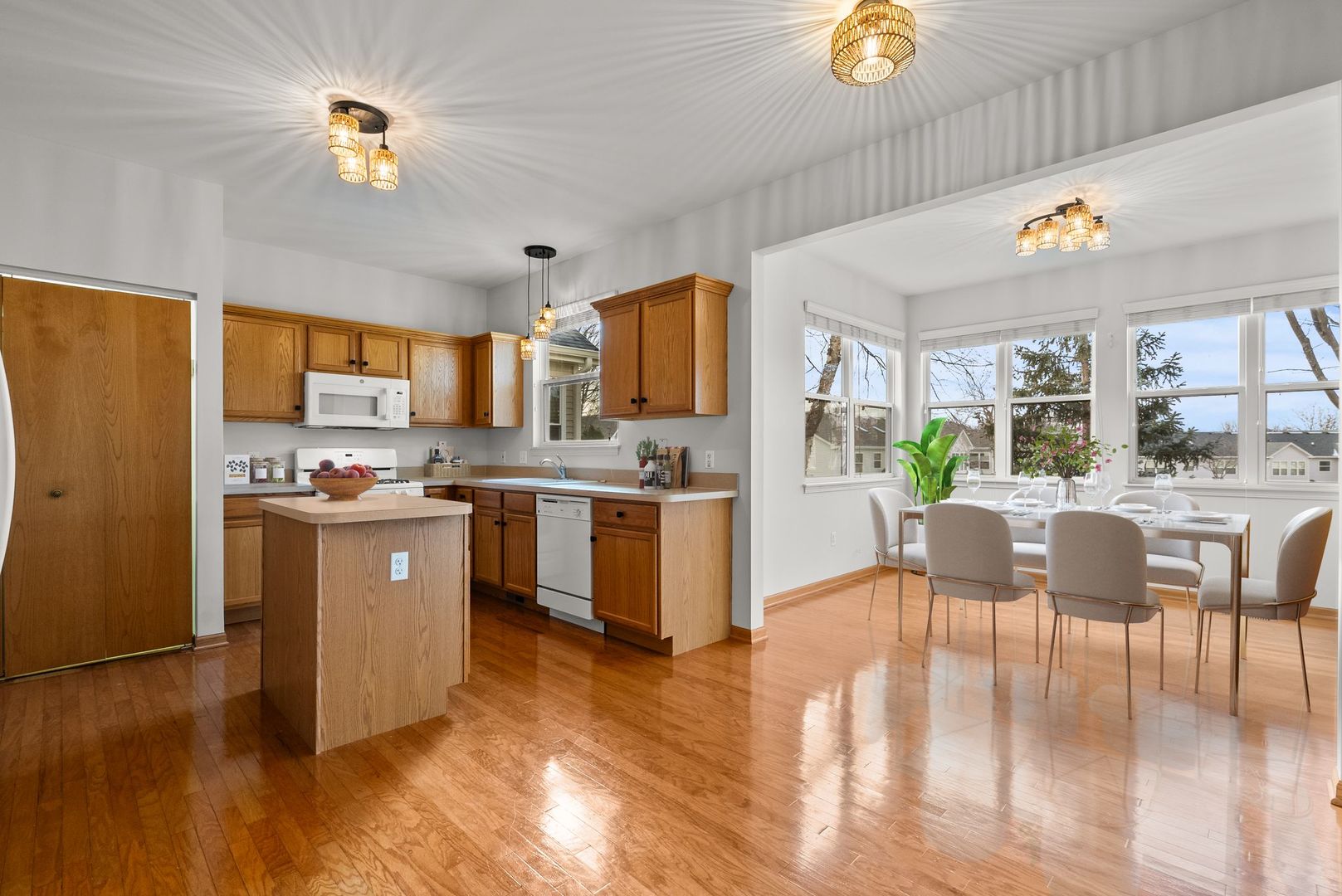 1534 Cadillac Circle Romeoville, IL 60446 - Photo 4 of 25 a kitchen with a table chairs refrigerator and microwave