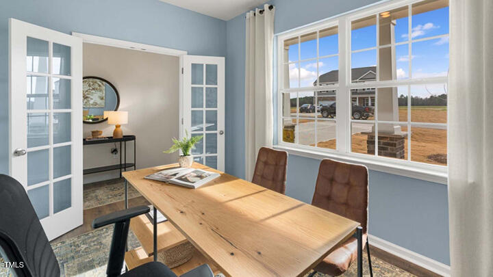 1245 Pavo Path Wendell, NC 27591 - Photo 6 of 48 a view of a dining room with furniture window and wooden floor