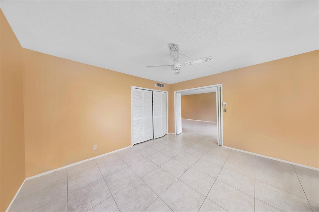 2681 South Course Drive, Unit 301 Pompano Beach, FL 33069 - Photo 11 of 27 a view of an empty room and chandelier fan