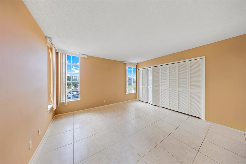 2681 South Course Drive, Unit 301 Pompano Beach, FL 33069 - Photo 16 of 27 a view of an empty room with a window