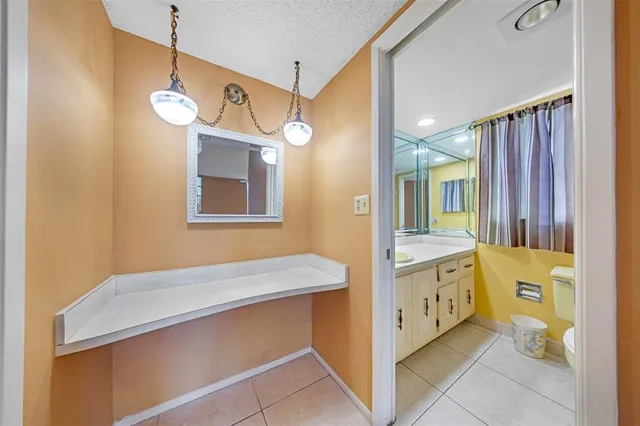 a bathroom with a sink a vanity and a large mirror